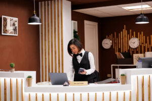 Front,Desk,Staff,Holding,Pos,Terminal,In,Hotel,Lobby,,Preparing